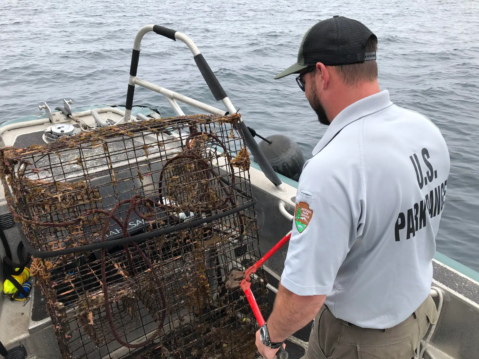 ranger on boat with lobster traps